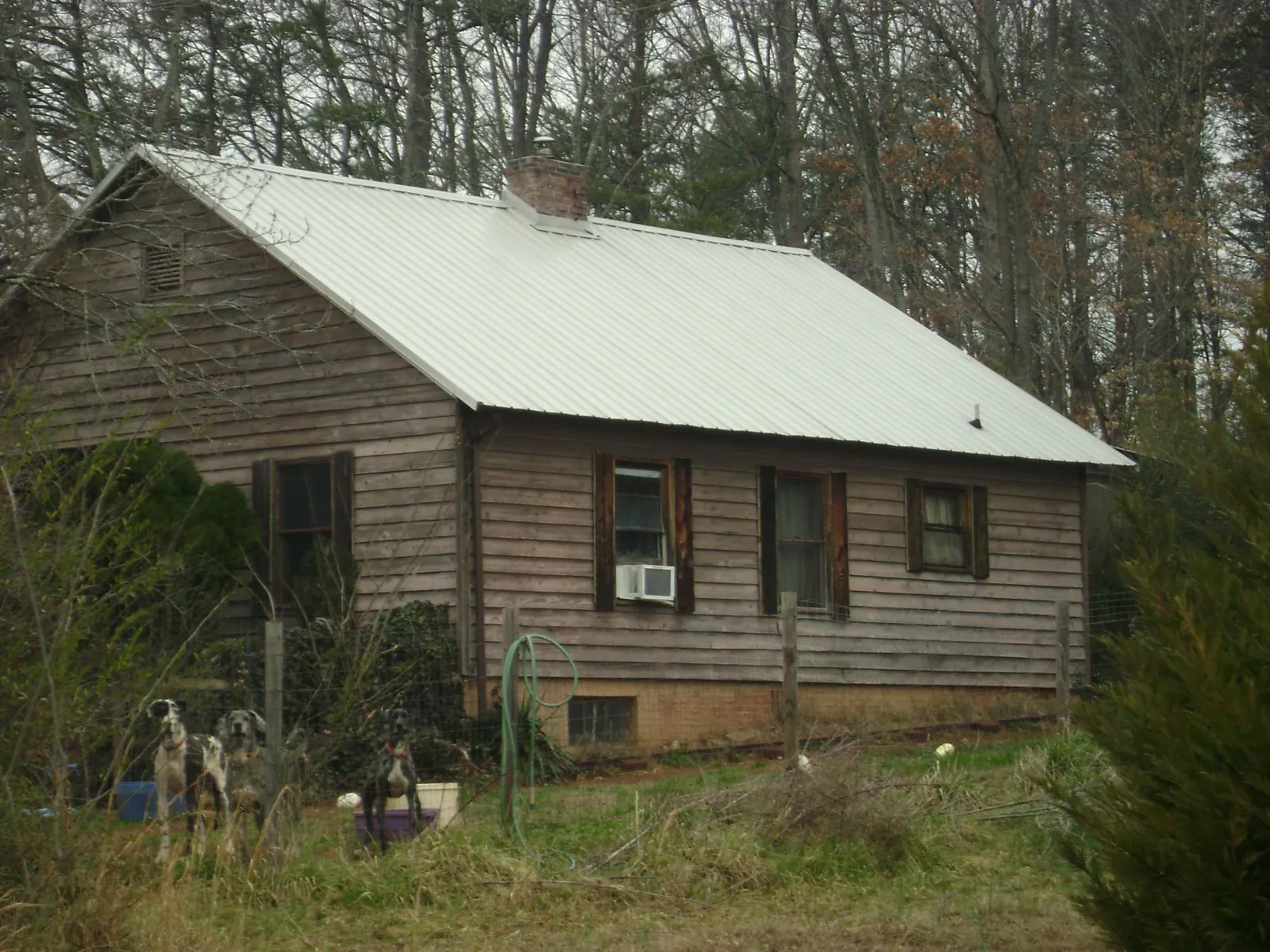 White metal roof on an old wood sided farmhouse, from a Metal Roof Installation job in Salisbury